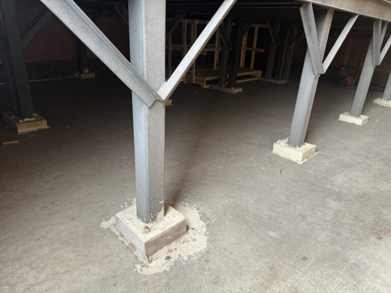 Concrete footing for base plate